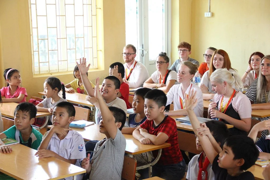 Teachers observate a class at a Fluent's partner school