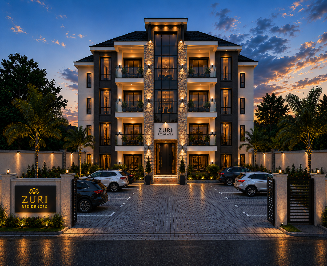A modern, multi-story residential building at dusk, with warm exterior lighting, a landscaped front yard with palm trees, and a parking lot with several cars. The building has balconies, large windows, and a sign that reads "Zuri Residences."