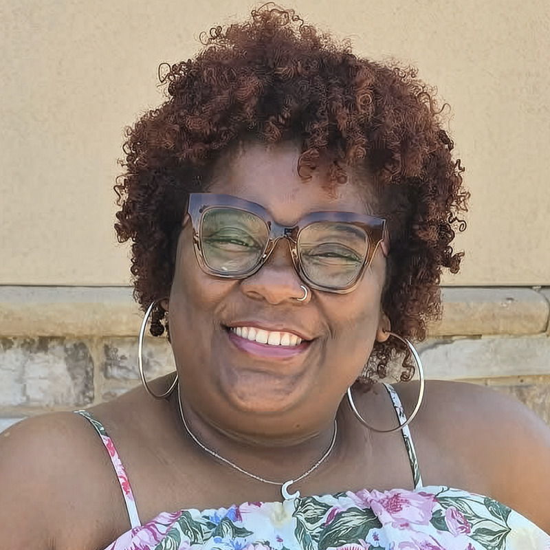 A happy adult patient showing beautiful smile results from her treatment with Dripping Springs orthodontist Dr. Avery Gil.