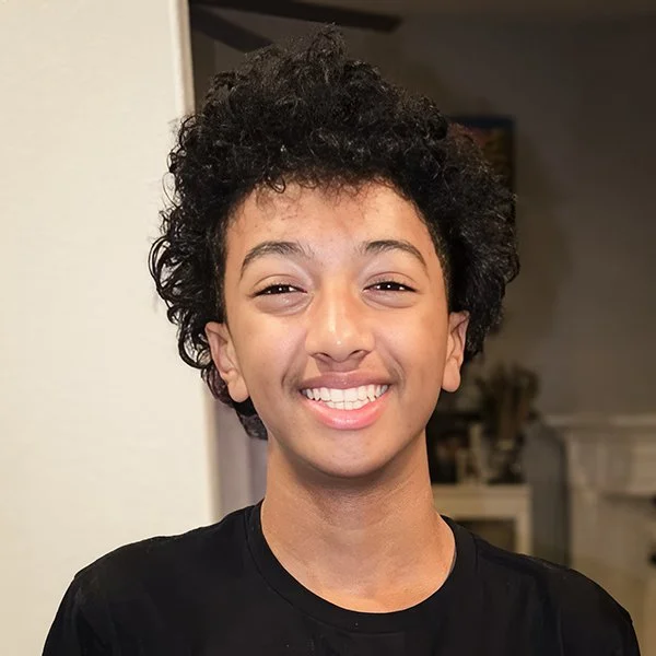 Portrait of a happy teenager with a confident smile, representing adolescent orthodontic care at Gil Orthodontics.