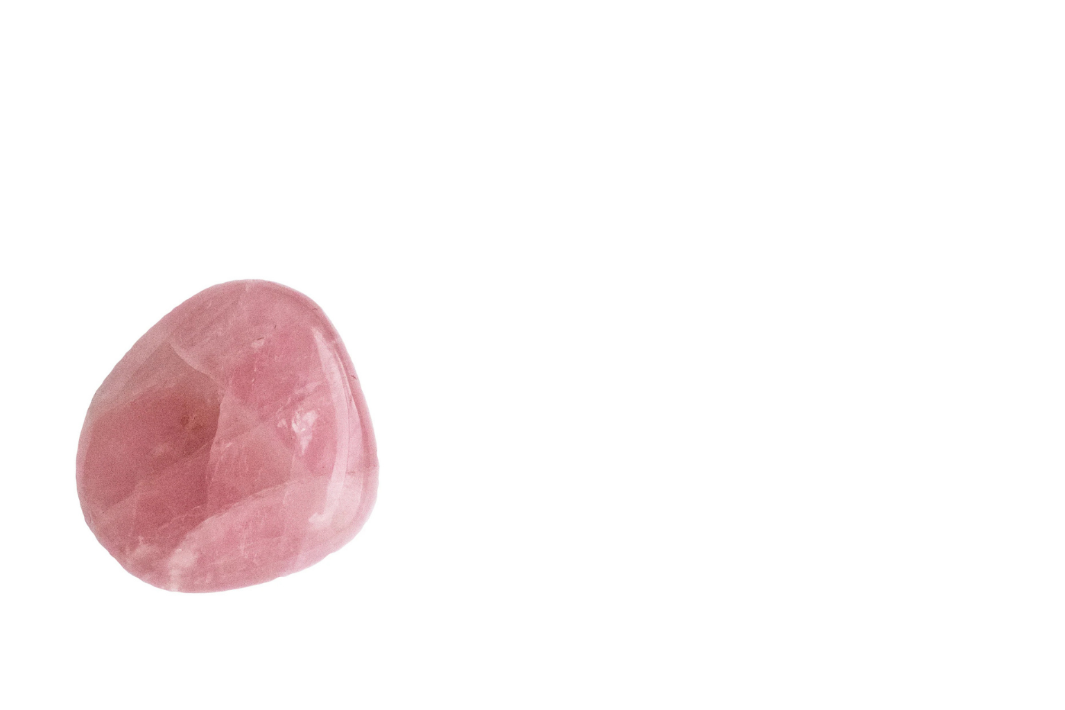A pink salt crystal with a rough, uneven surface, isolated on a white background.