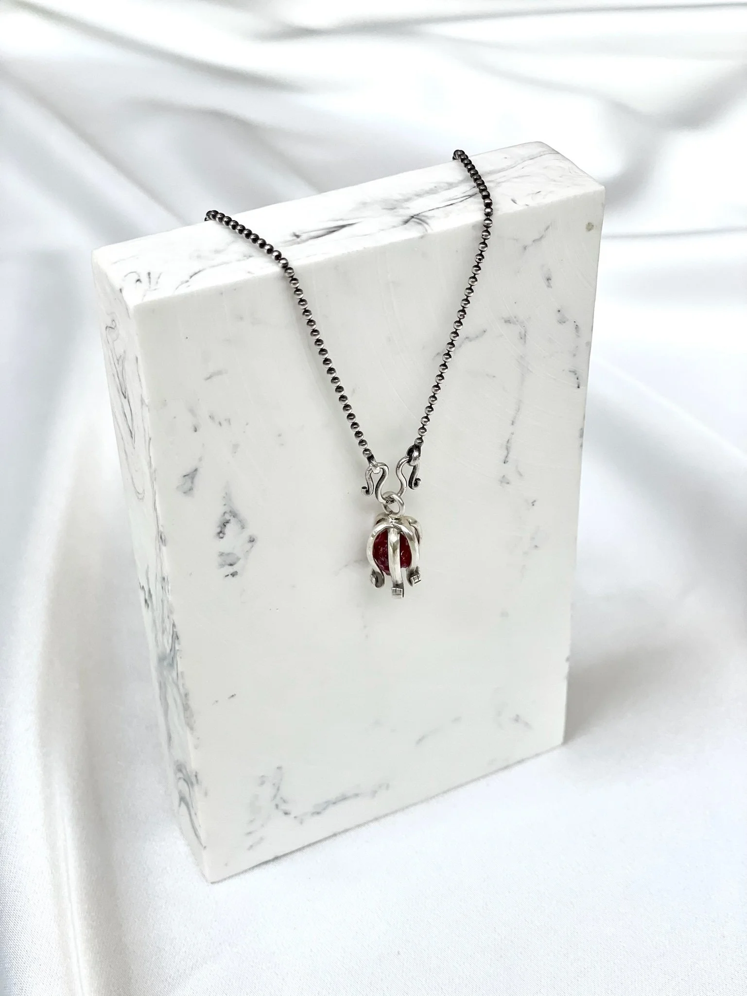 raw-garnet-silver-necklace-flatlay.jpg