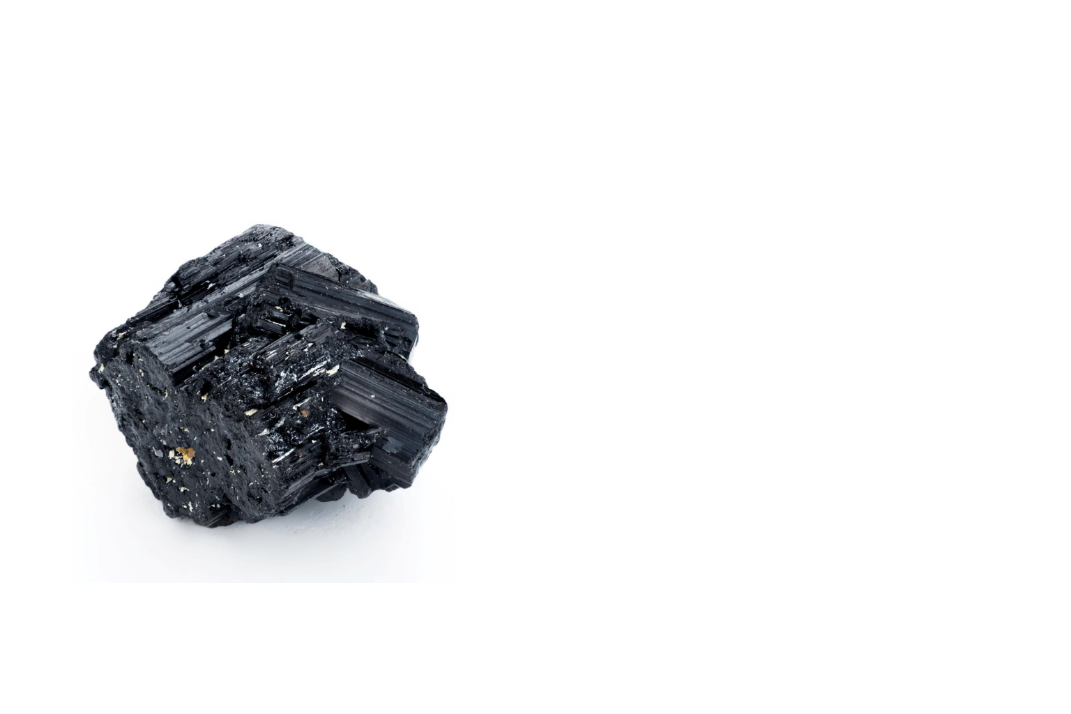A black tourmaline crystal on a white background.