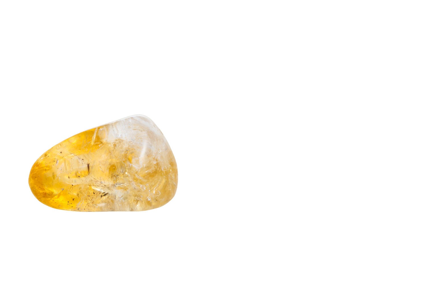 A polished, yellow and clear gemstone on a white background.