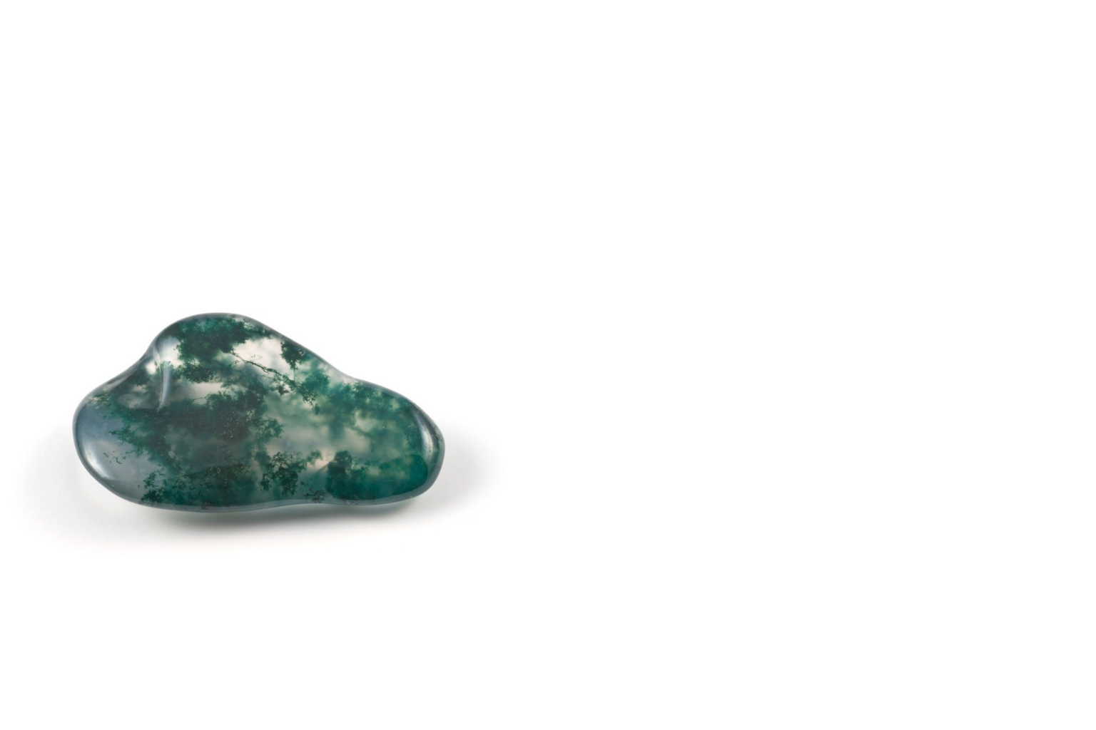 Green and black patterned polished gemstone on a white background