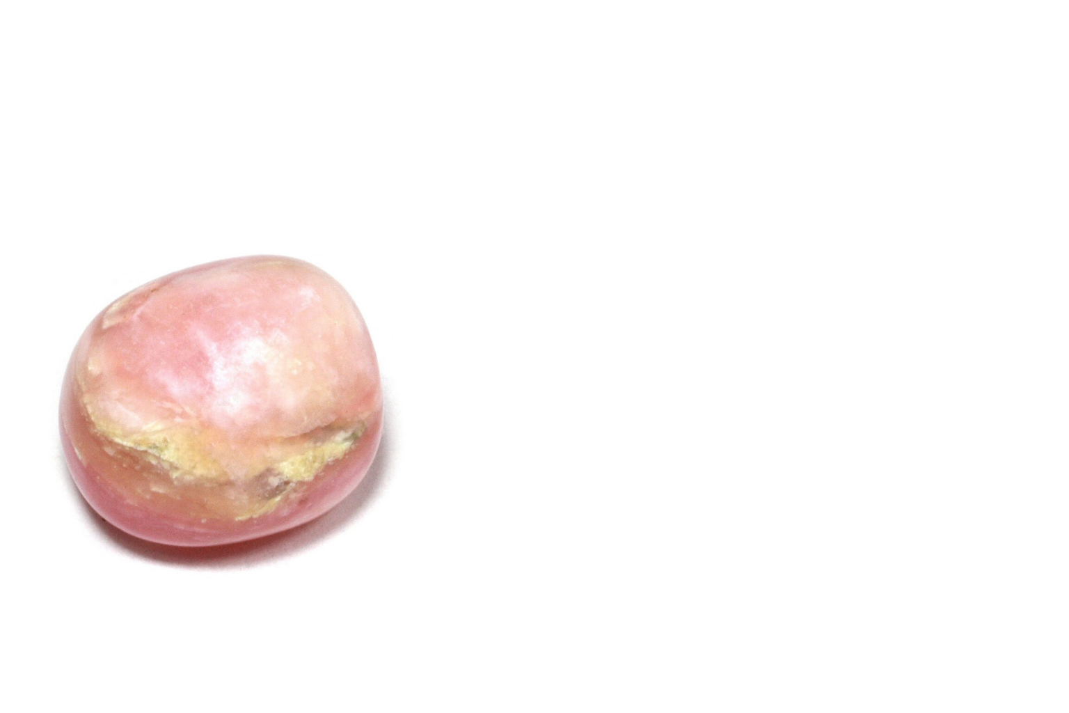 A close-up of a peach with a pinkish hue and some damage or mold on its surface, placed on a white background.