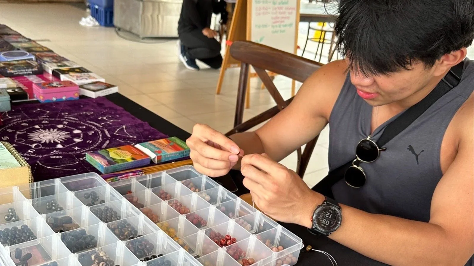 Selecting gemstones for a handmade bracelet during a jewelry workshop in Phuket