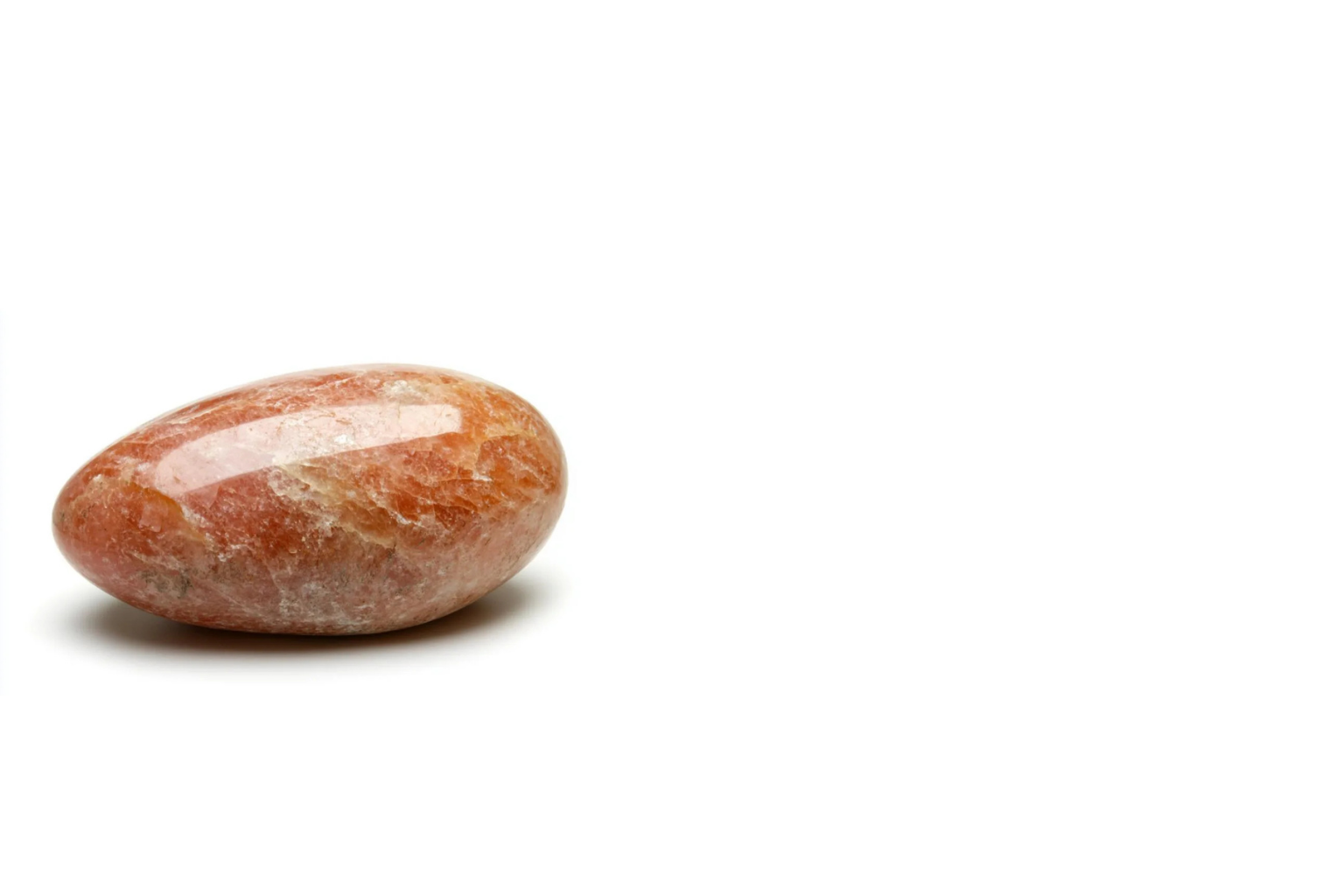 Polished orange-pink stone on white background.