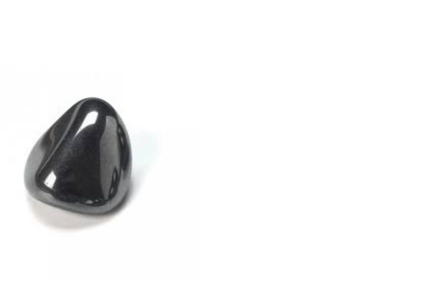 Close-up of a black, shiny, triangular-shaped object with rounded edges on a white background.