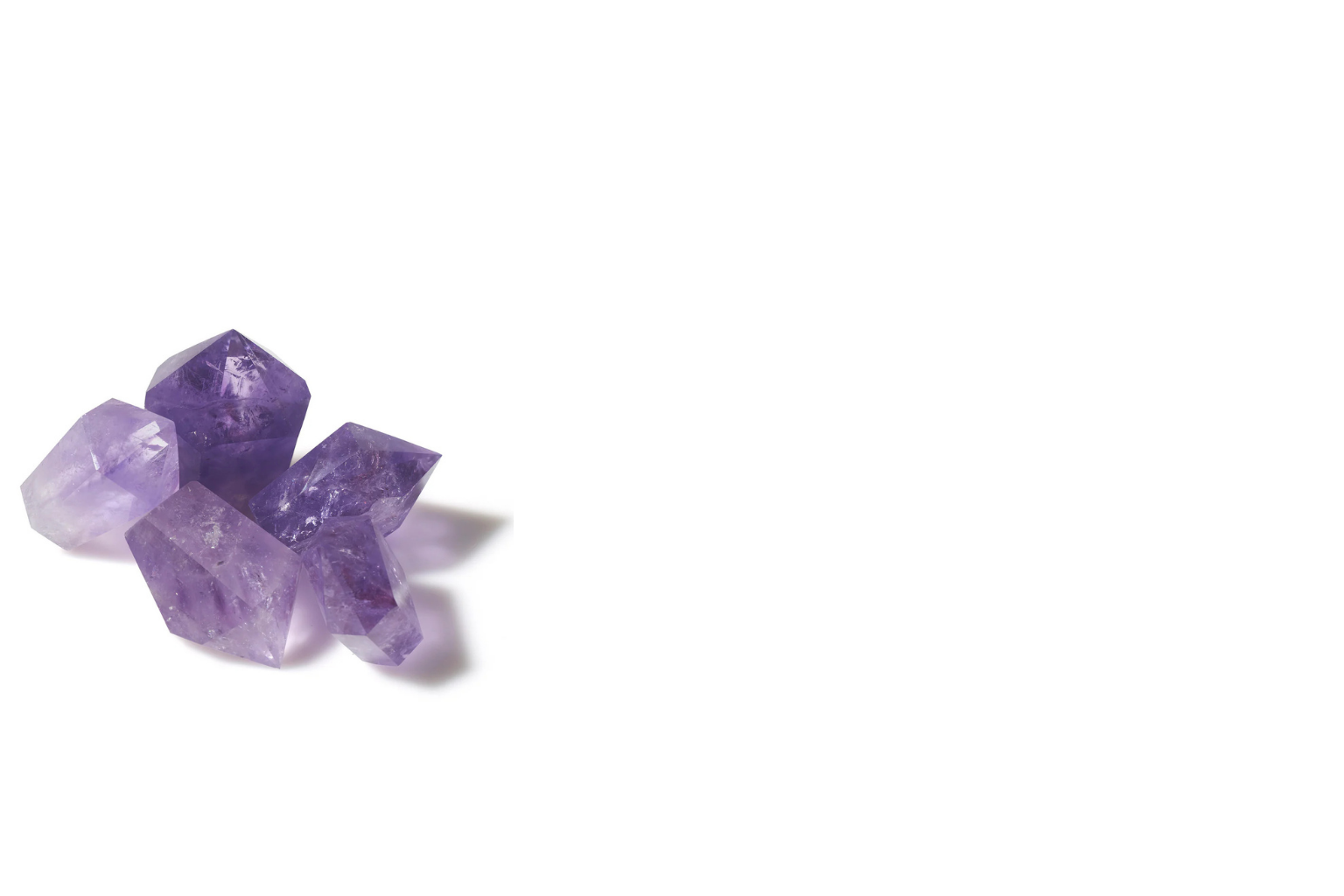 Five cut and polished purple amethysts on a white background