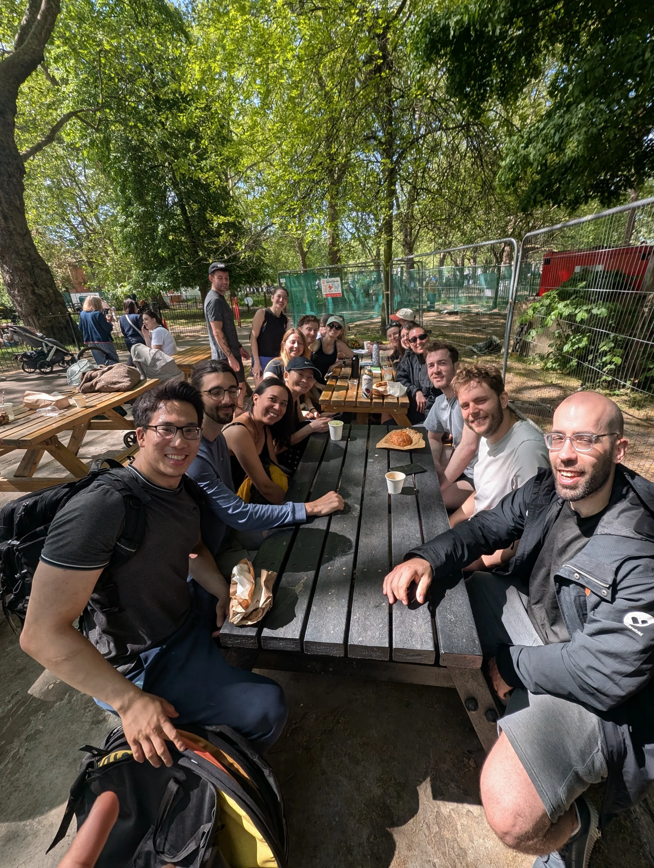 the strong community (20+ people) of wild LDN having a coffee after a high energy outdoor fitness class in Highbury Fields, Islington