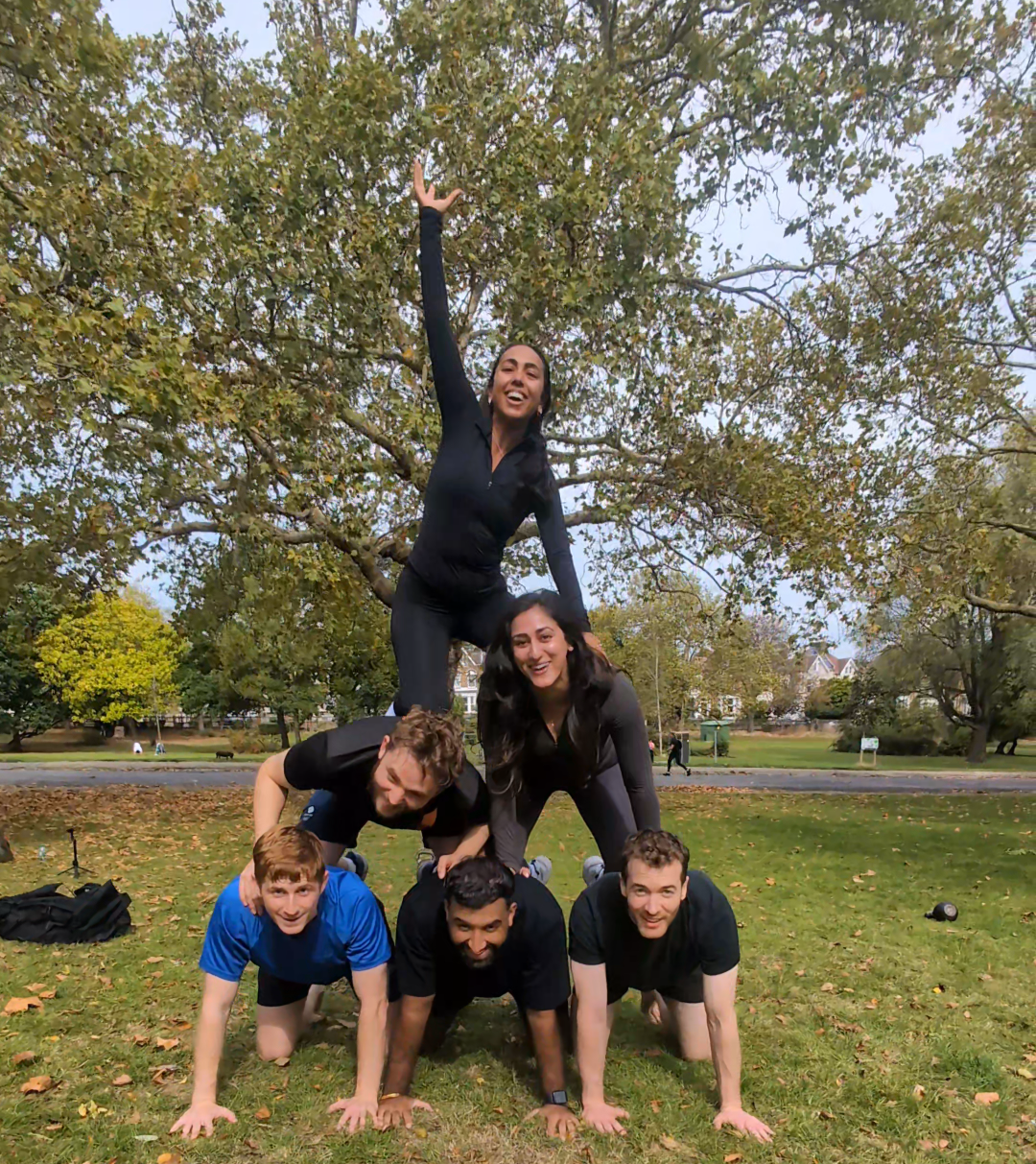 team picture from after a wild LDN session in Finsbury Park, Islington - a group of athletic people sweaty and very happy after the outdoor fitness group class in a beautiful London park