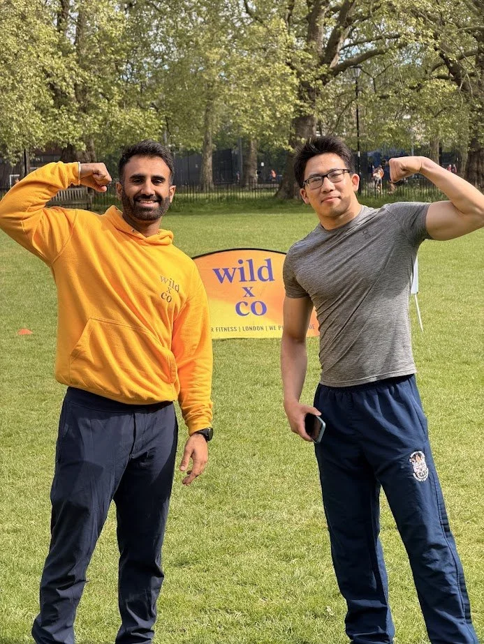 some of the wild LDN coaching team during an outdoor fitness group class in Highbury Fields, Islington. they look strong and athletic and flex their biceps to show this
