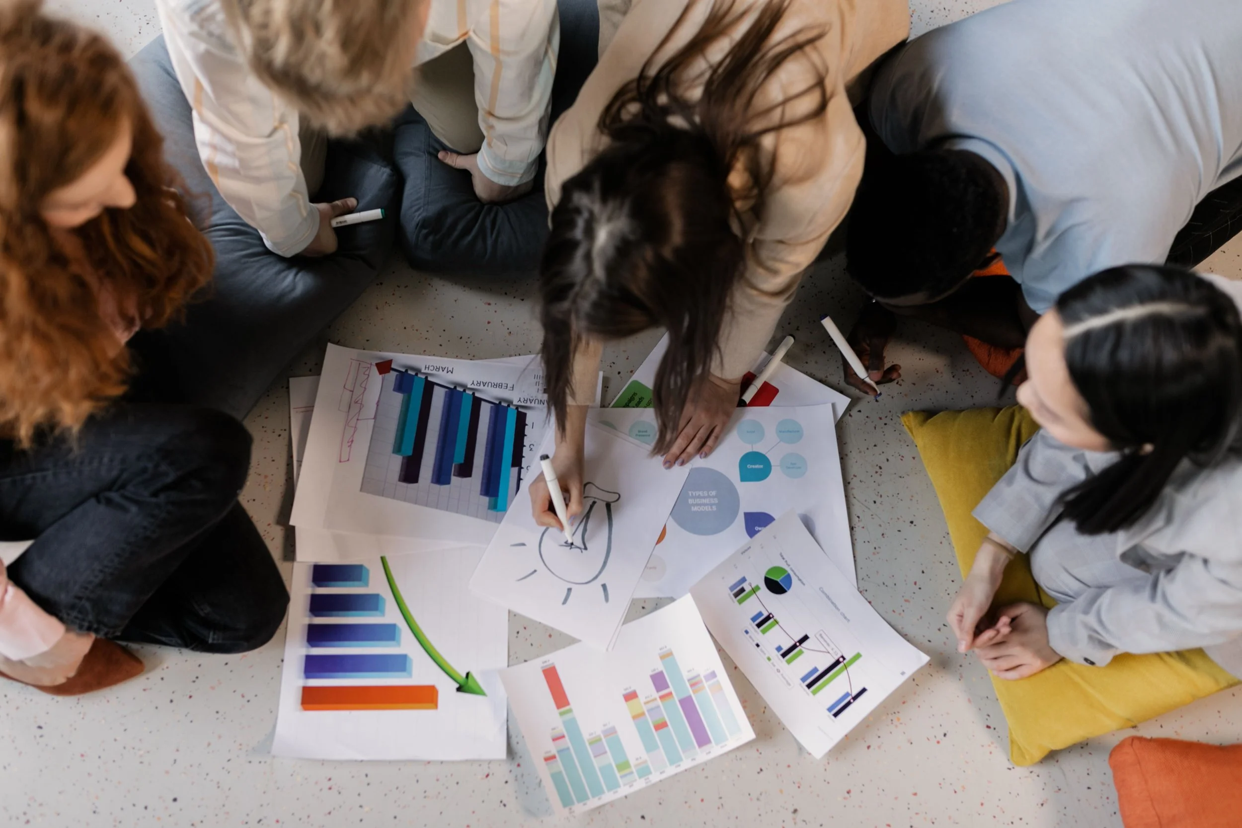 Image of people looking over papers with various graphs
