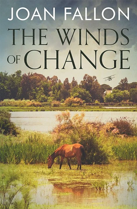 Book cover for The Winds of Change by Joan Fallon showing a scene from the national park Doñana and a horse grazing.