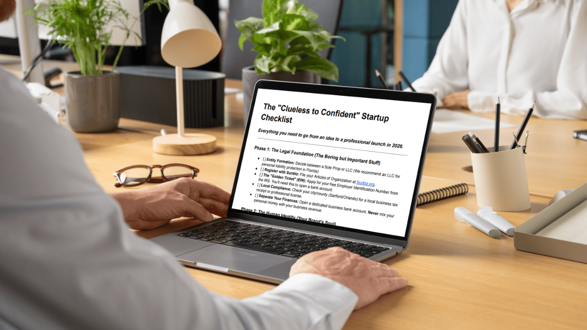 Laptop on a desk with the "Clueless to Confident Startup Checklist" on the screen
