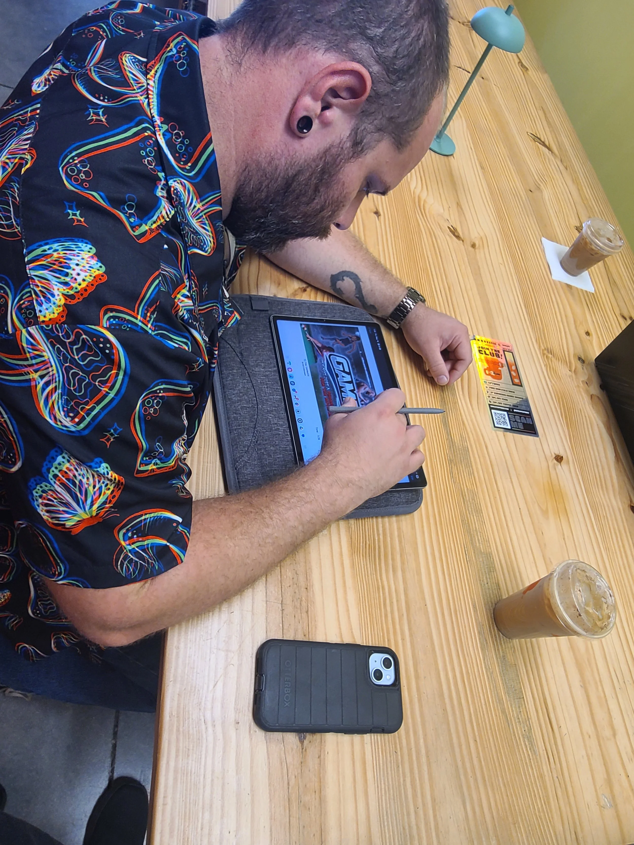 Man at a desk drawing on a tablet