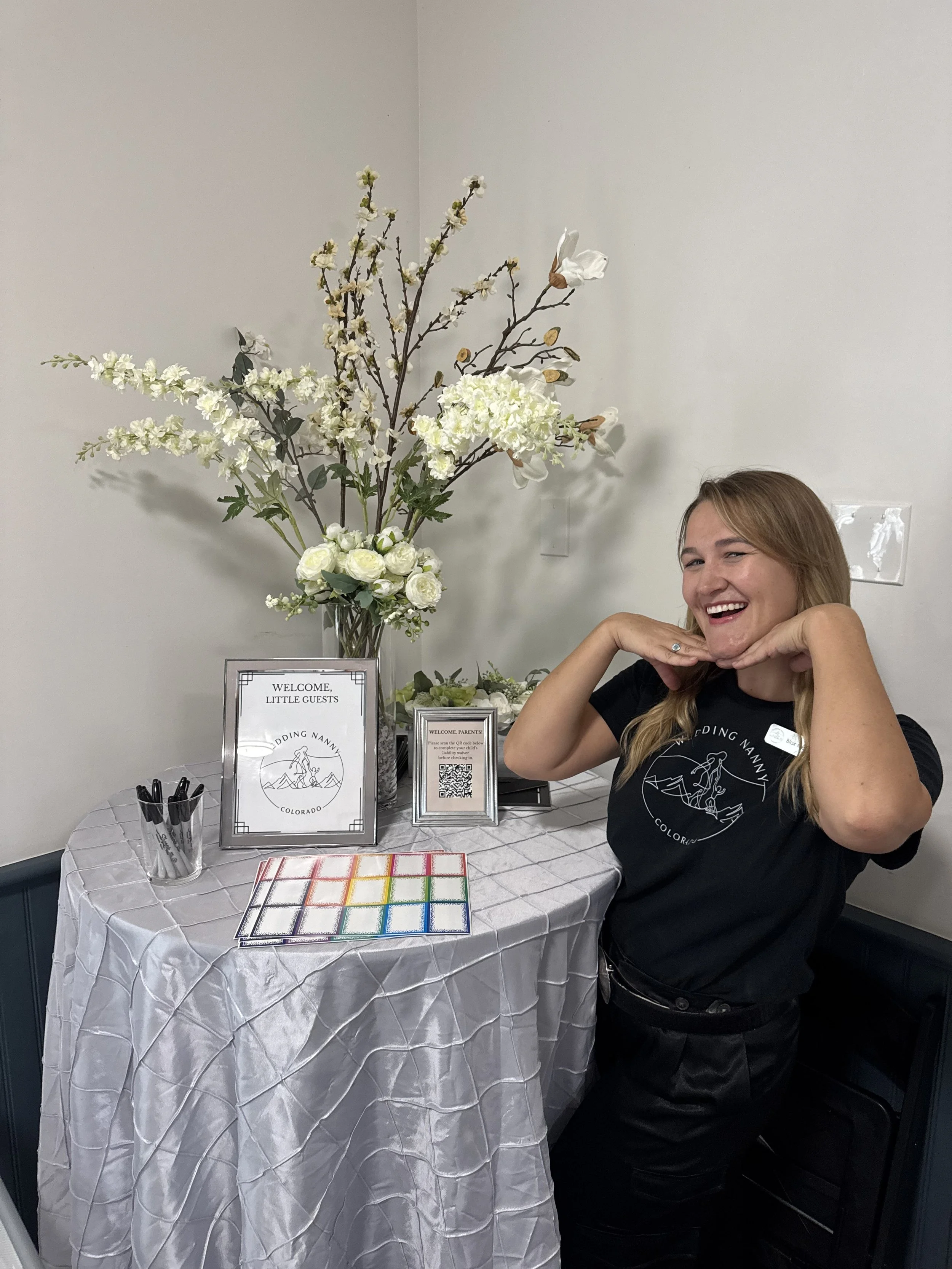 Lead wedding nanny showcasing the check in table at a venue.