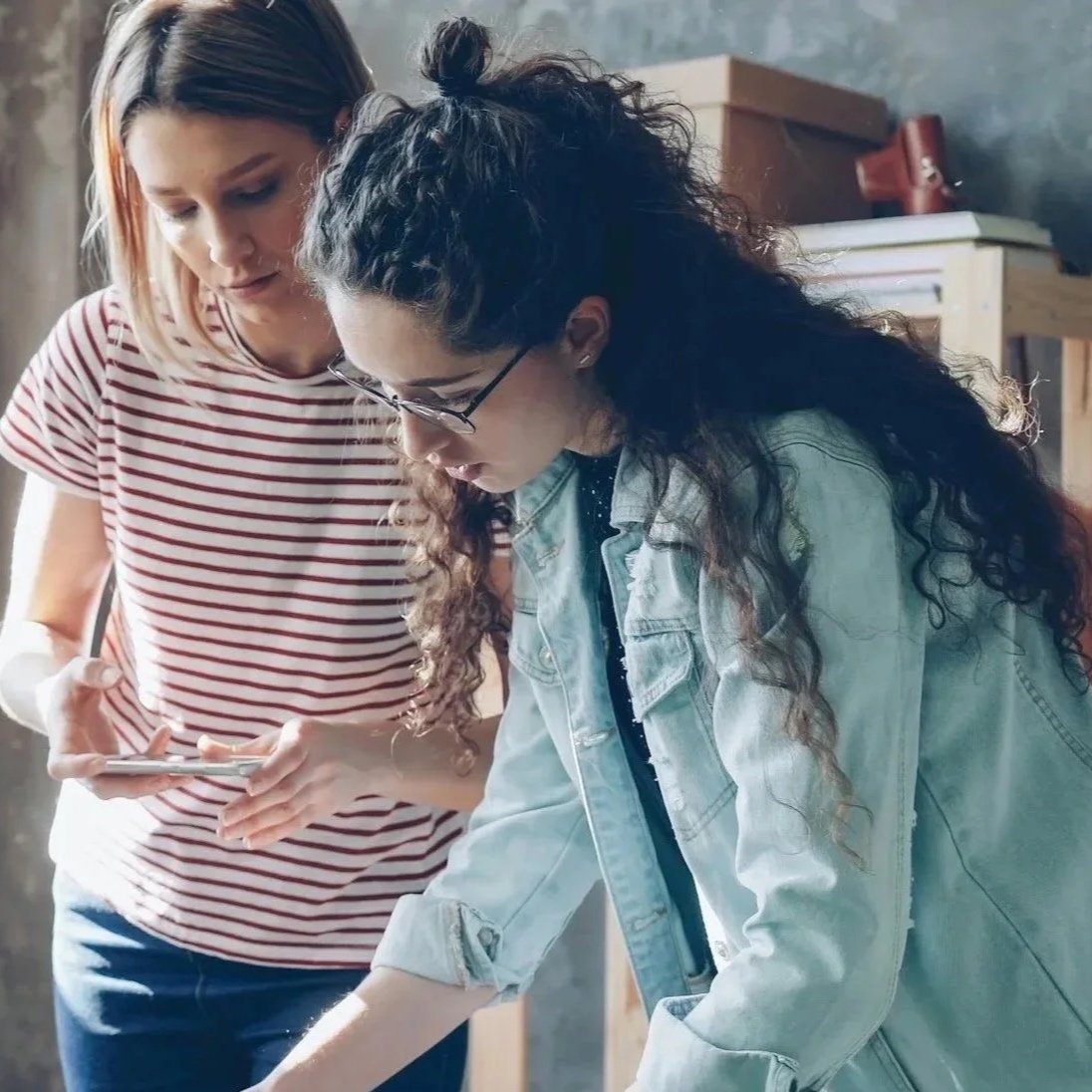 Adult mentor guiding a teenage girl through a problem-solving activity — critical thinking education for teens and tweens