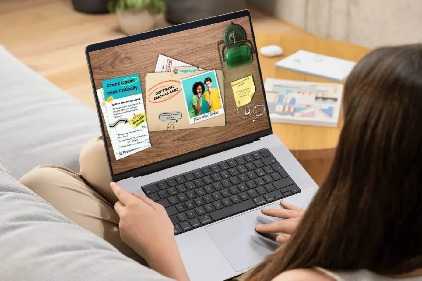 Person viewed from behind using a laptop to access Critical Thinking Lab resources at a wooden desk.