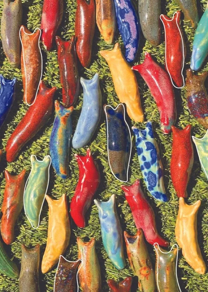 Colorful glass slug sculptures with outlines on a green textured background.