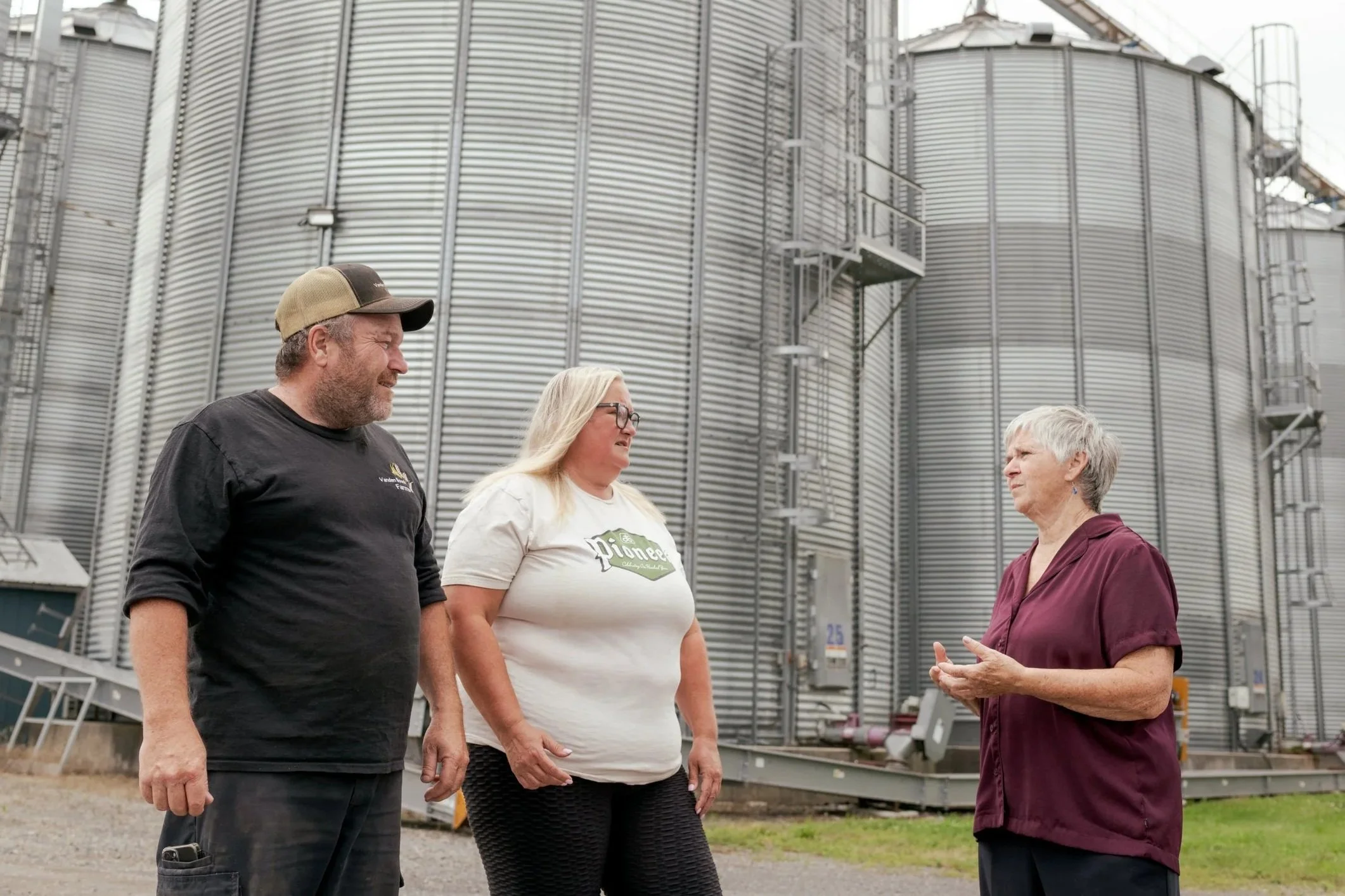Theresa Bergeron having a discussion with two North Dundas residents on their farm.