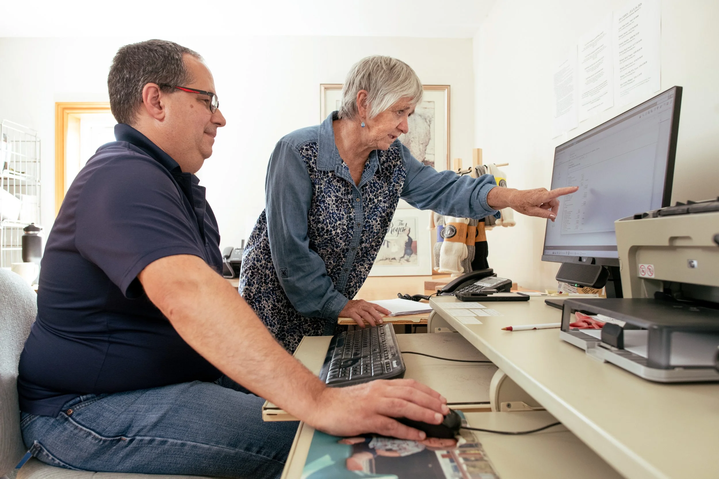 Theresa Bergeron reviewing business data with a colleague.