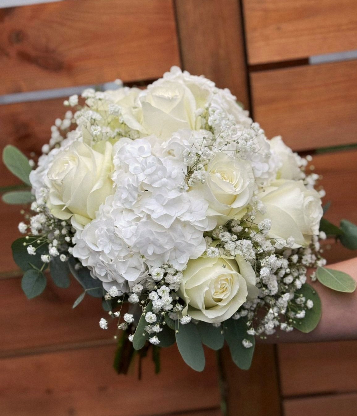 A classic wedding bouquet. White roses, hydrangeas, and baby's breath.