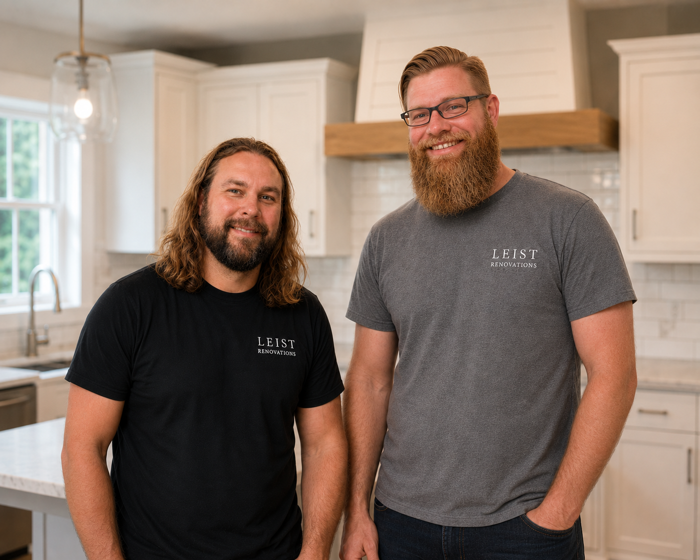 Two men standing in a kitchen, both wearing shirts with 'Leist Renovations' logos, smiling at the camera.