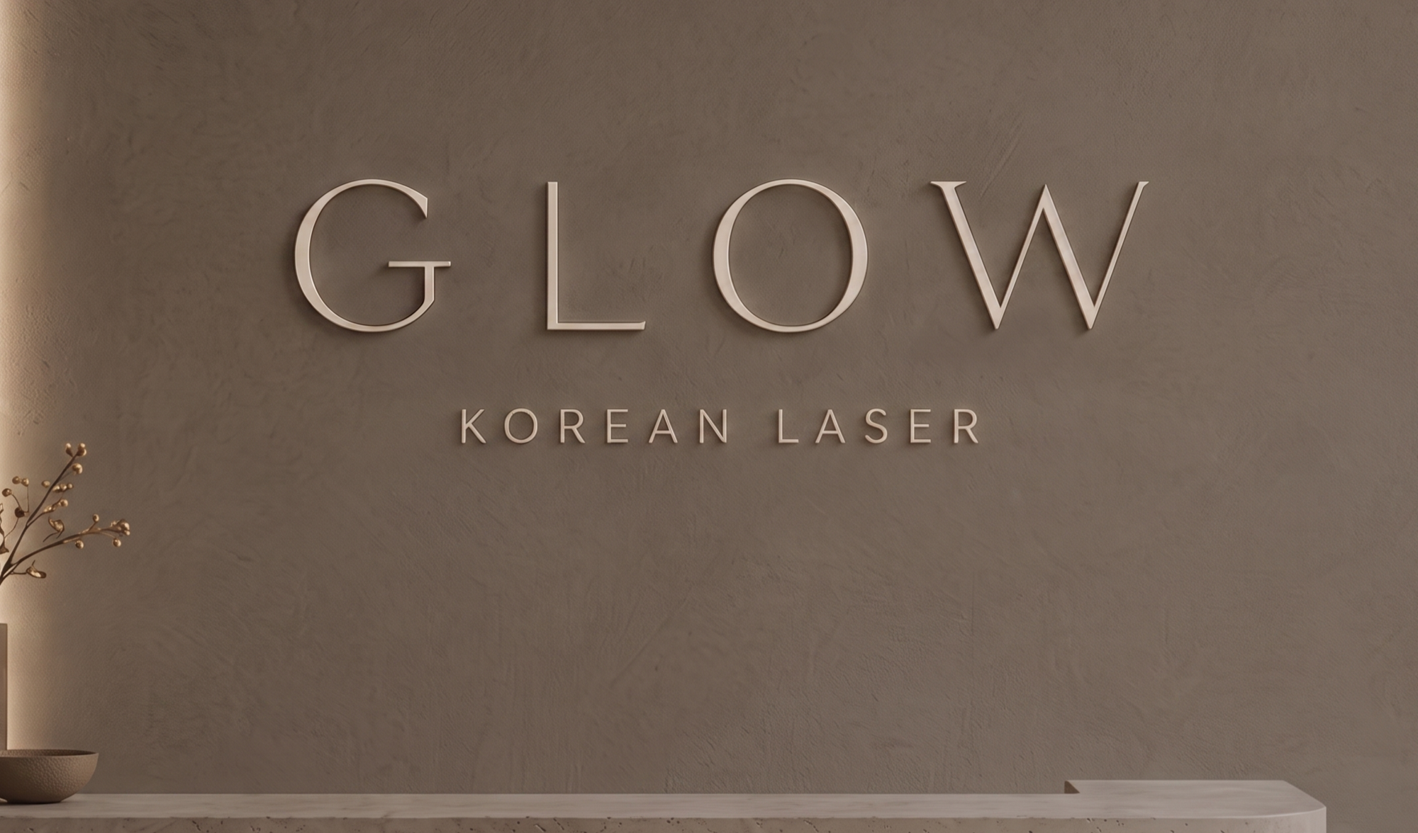 Wall sign reads 'GLOW KOREAN LASER' in large letters with a minimalist aesthetic.