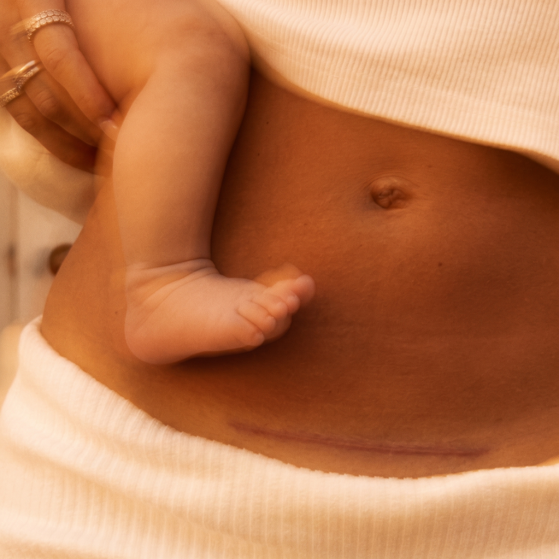 Close-up of a person's chest with hand and fingers partially covering the nipple.