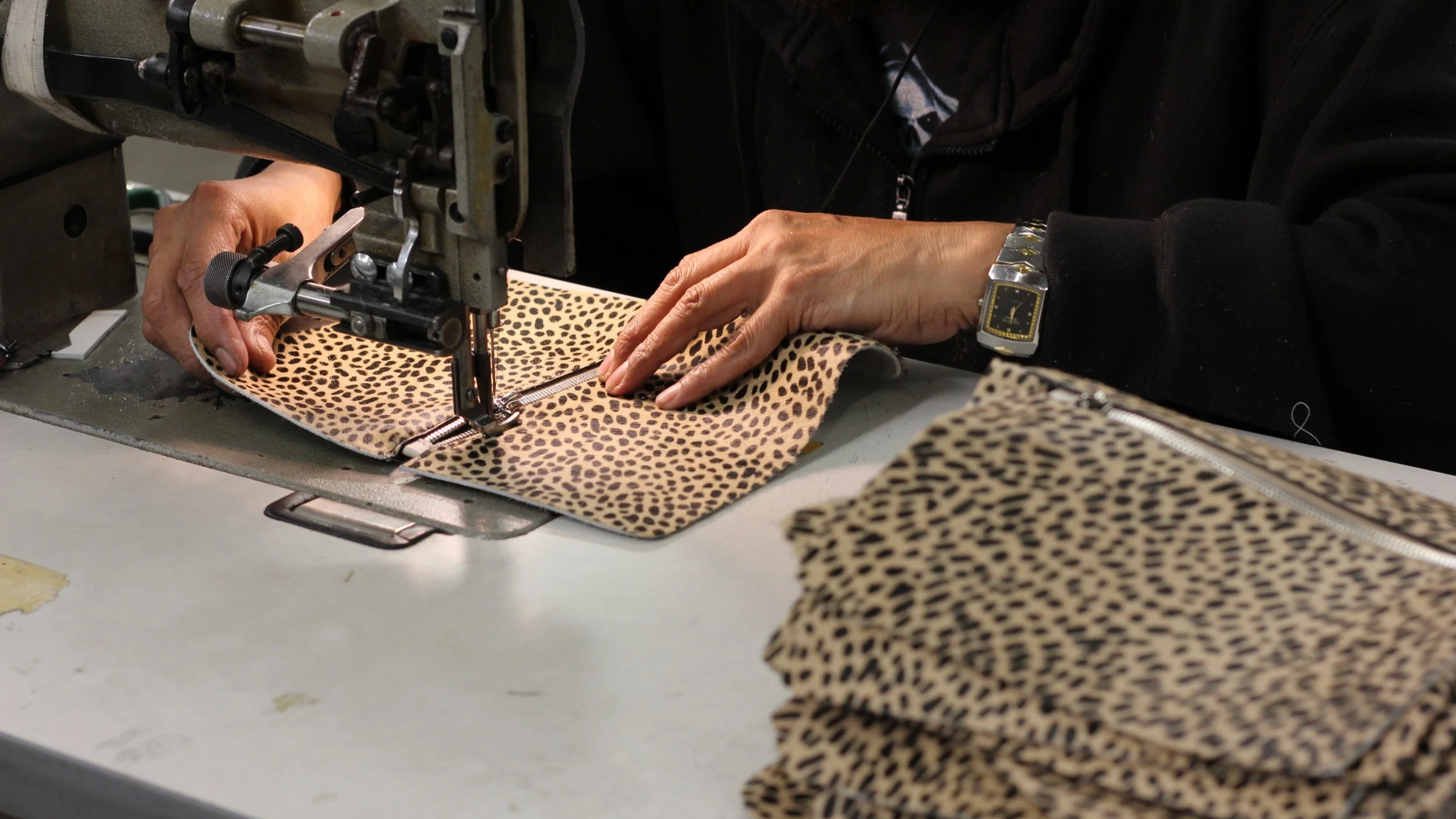 Factory worker in Los Angeles sewing handbags