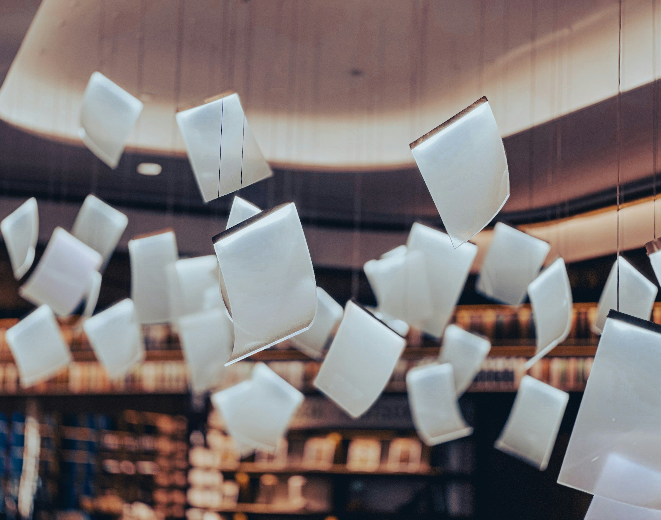 Papers floating above a library
