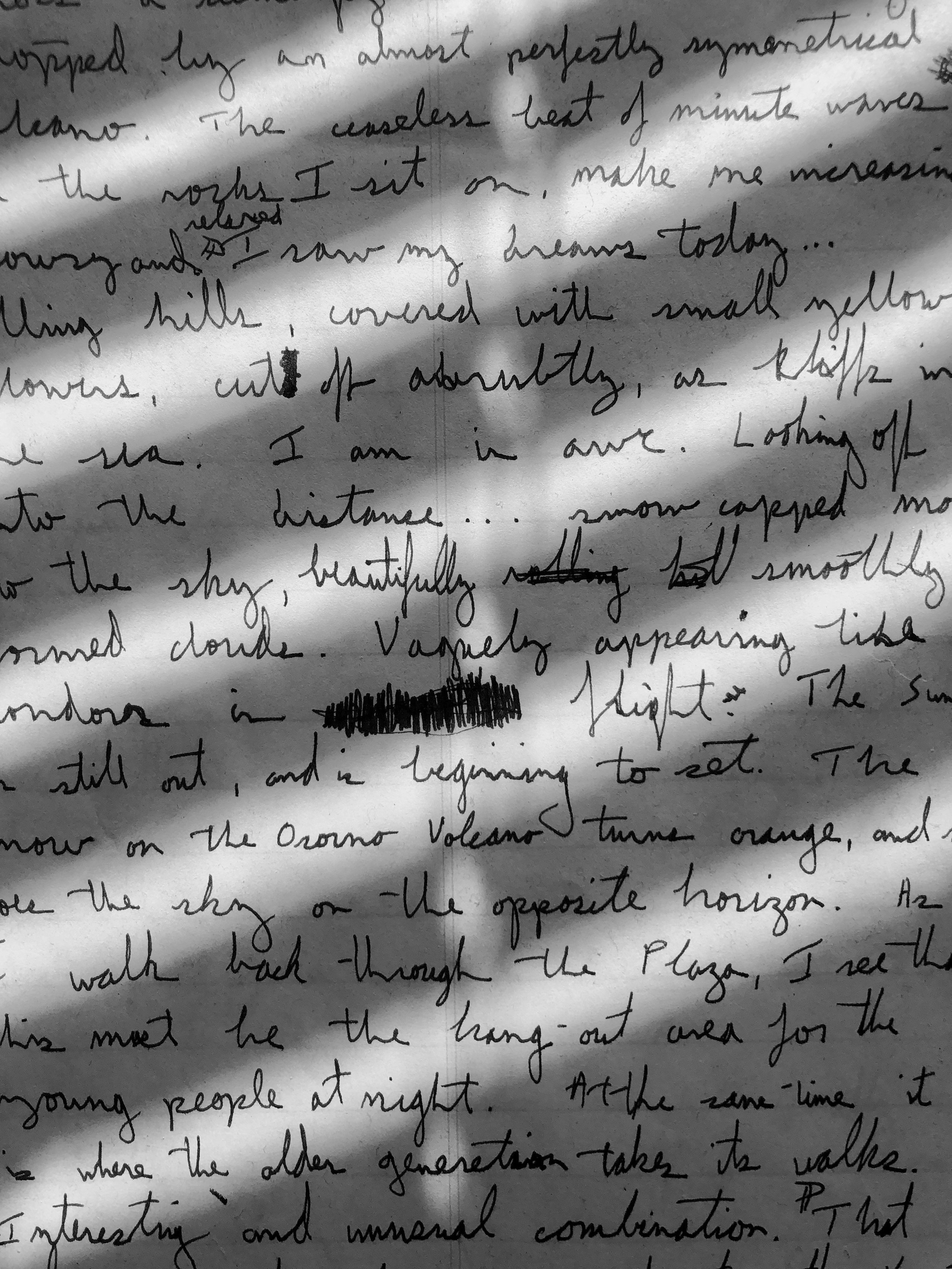 Close-up of a handwritten letter, partially visible, with a shadow across the paper, making some words difficult to read.