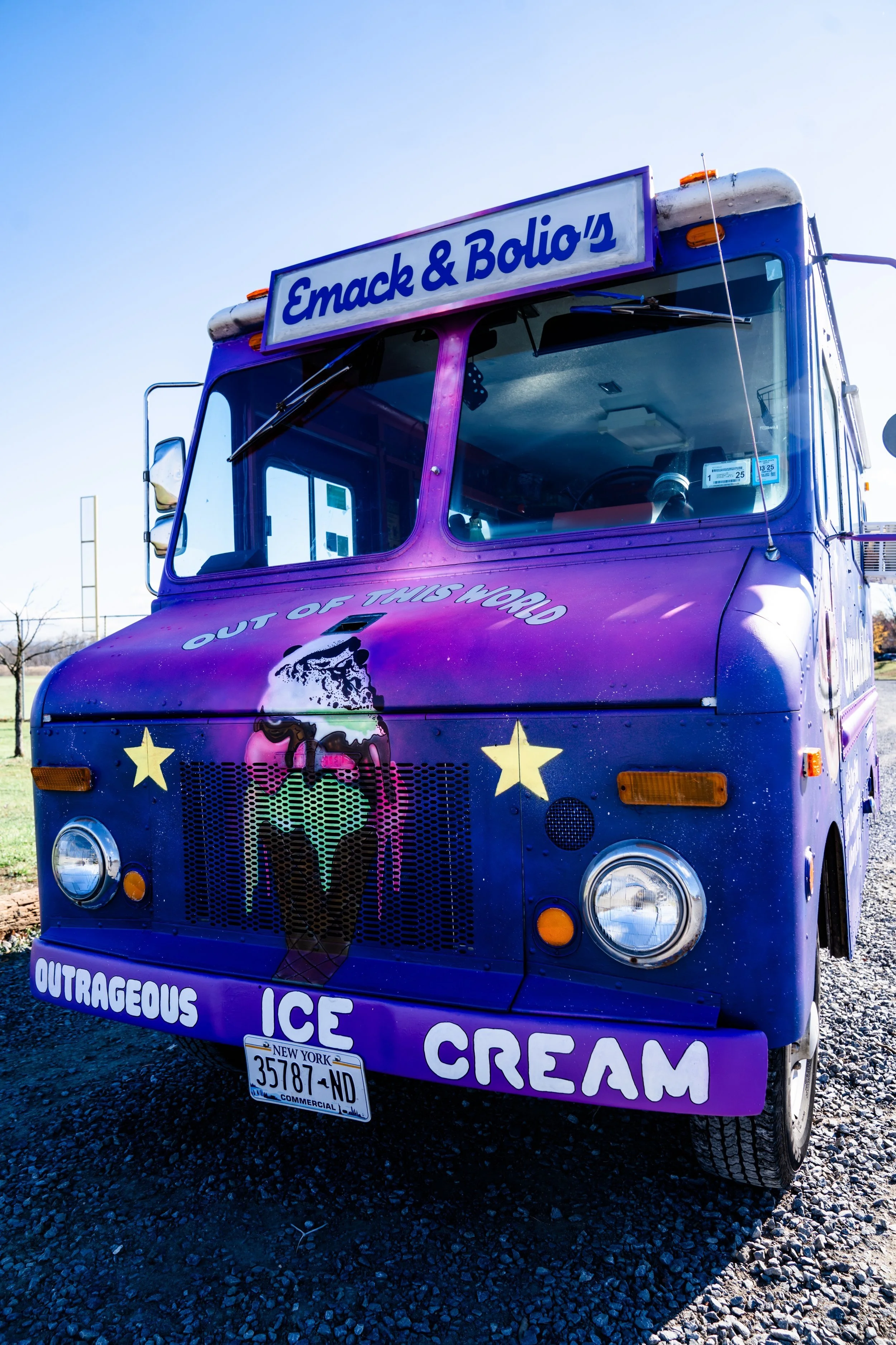 Emack & Bolio’s vintage ice cream truck parked at an outdoor event, serving handcrafted ice cream, frozen treats, and desserts in New York. The colorful branded truck  is available for weddings, private parties and corporate events.