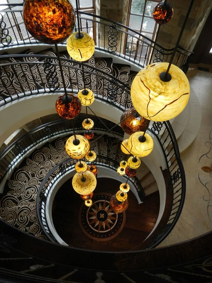 Pacific Northwest sculptor Chet Redmon Bellingham sculpture metal and hand blown glass chandelier custom iron hand railings forged artisan ironwork
