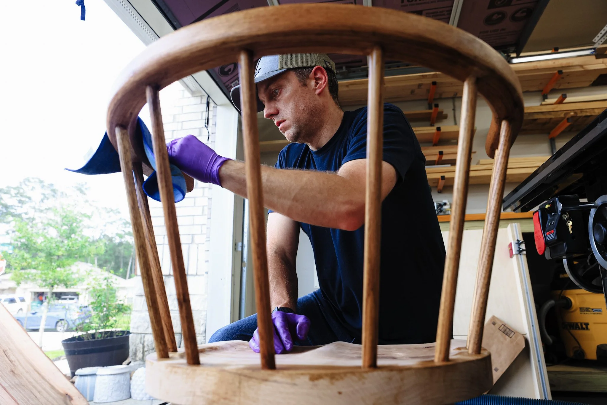 A man finishing a custom-made chair.