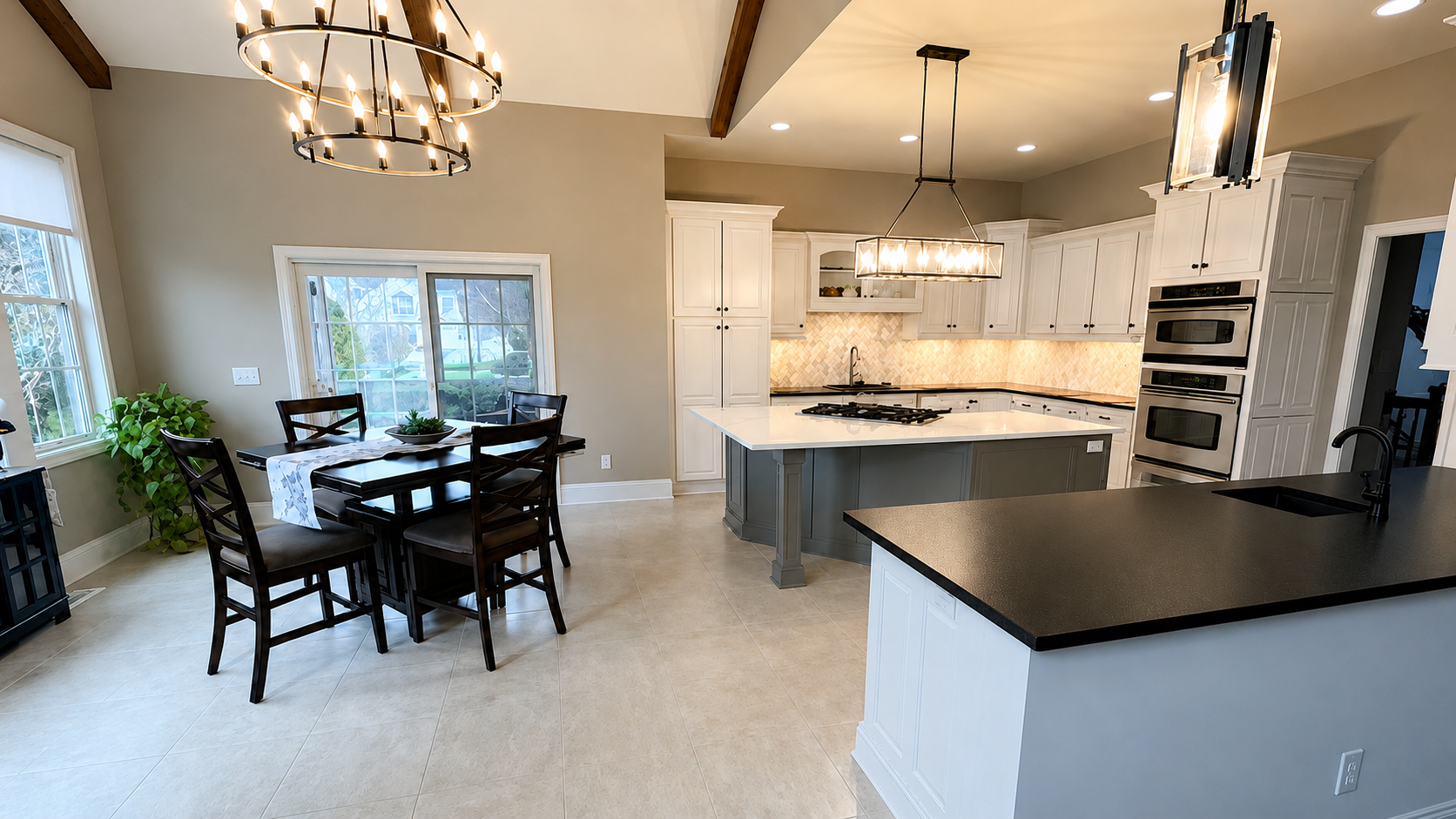 Bright modern traditional kitchen remodel featuring a large quartz island and updated crisp white cabinets.