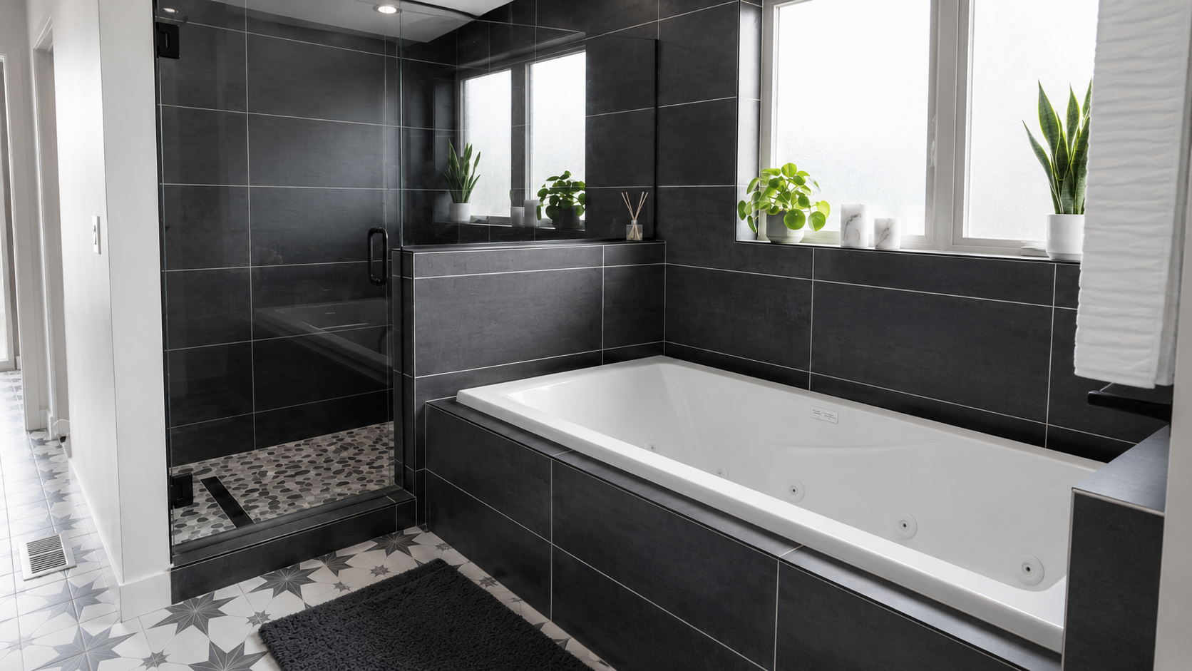Custom primary bathroom remodel featuring a frameless glass walk-in shower, large soaking tub with charcoal tile surround, matte black fixtures, patterned tile flooring, and frosted windows in Marengo, Ohio.