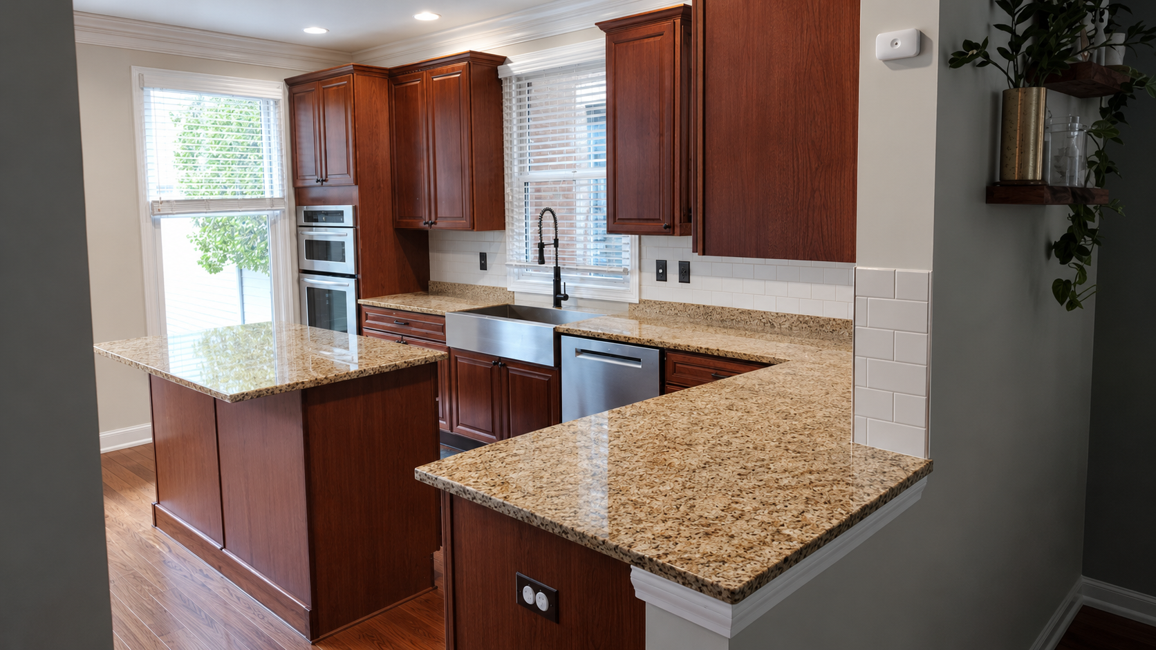 Kitchen before cabinet refacing featuring existing cherry wood cabinets, granite countertops, farmhouse sink, and peninsula layout prior to a custom cabinet refacing project in Ohio.