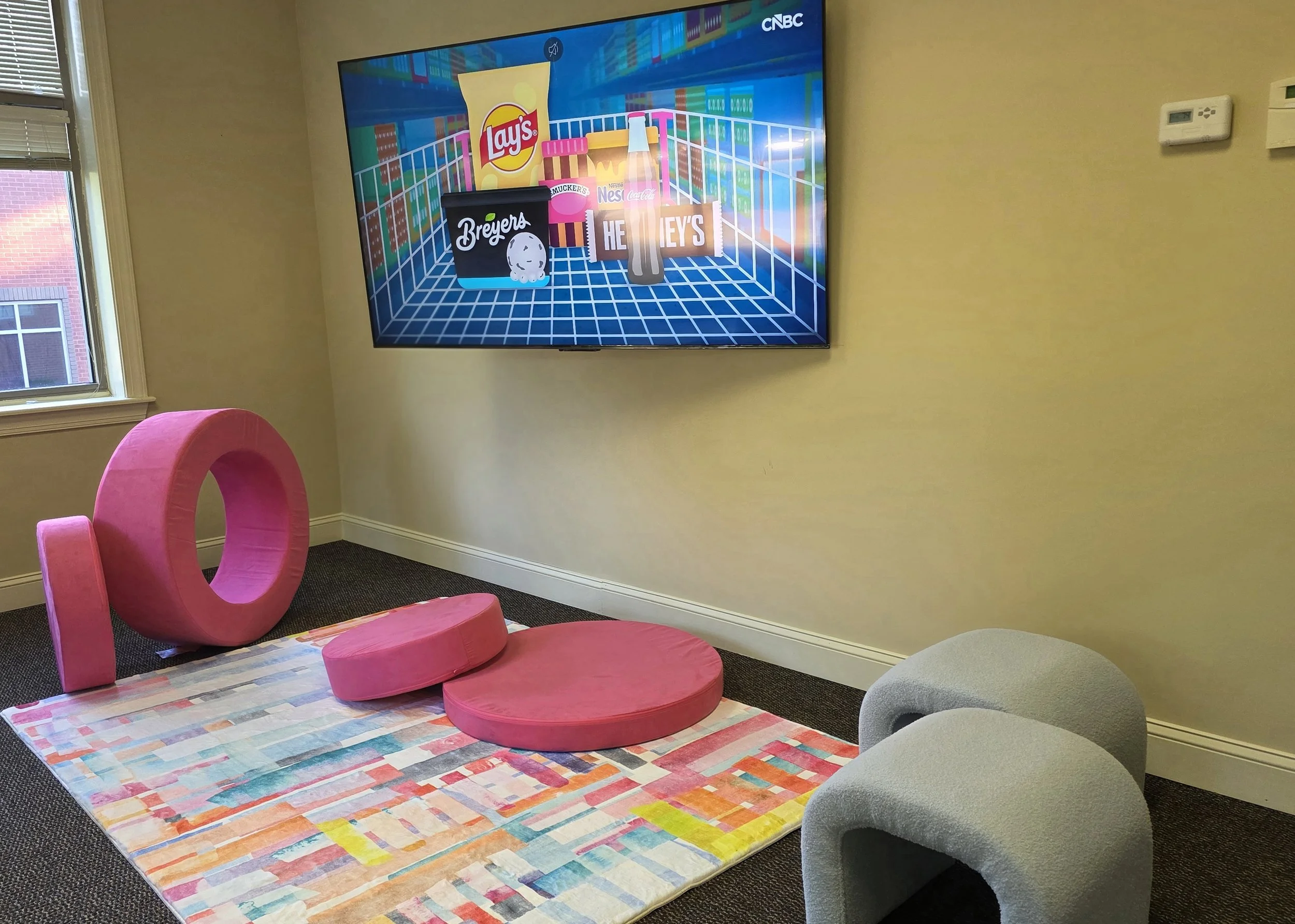 Media Zone: Ages 6-8. Big brains enjoy a big screen. In the Media Zone, children can choose plush or firm seating. (On screen: CNBC. One of our favorites to support creative thinking and problem solving!)