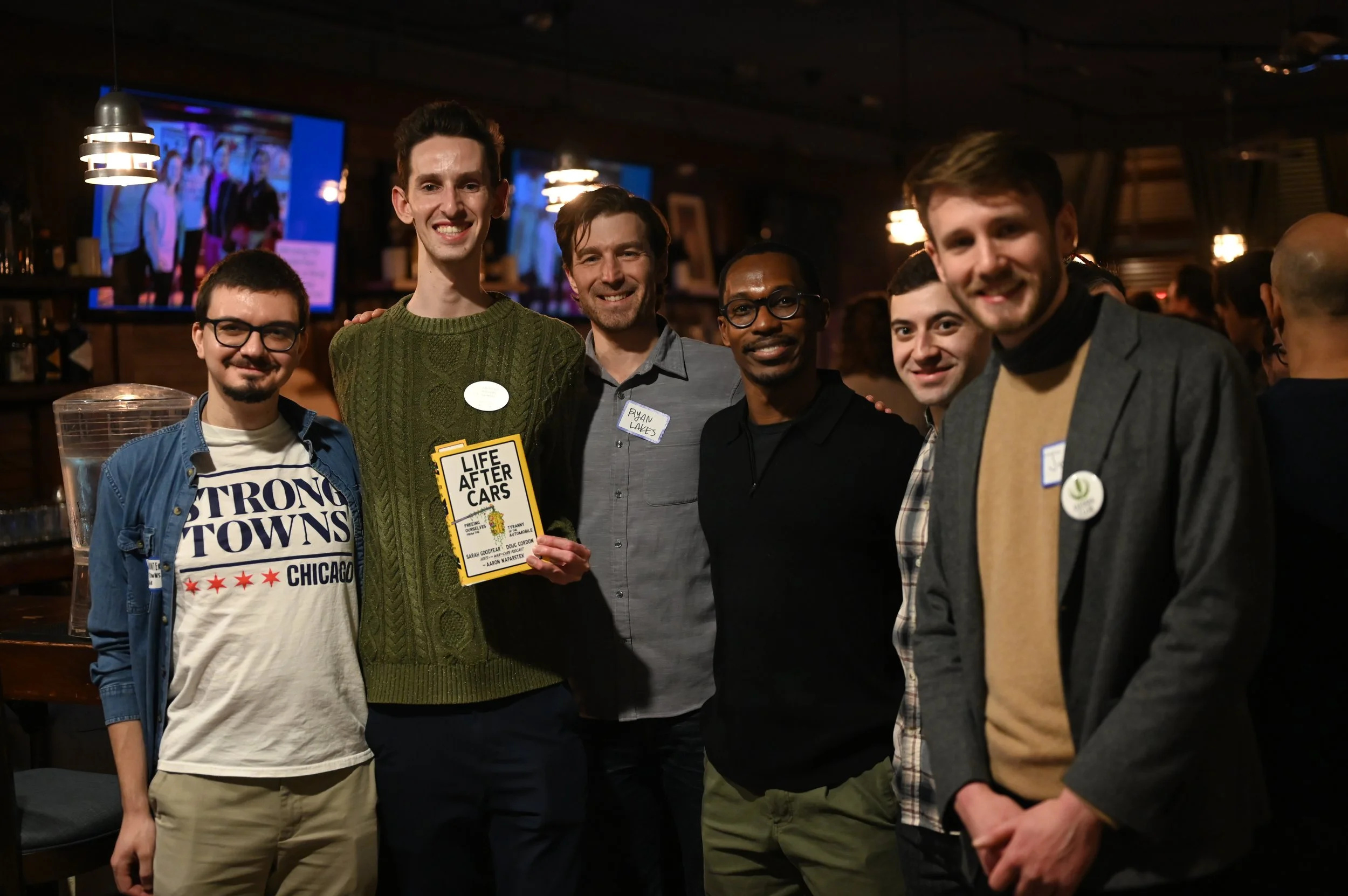 A group of volunteers posing with 27th Ward Alderman Walter 'Red' Burnett, December 2025.