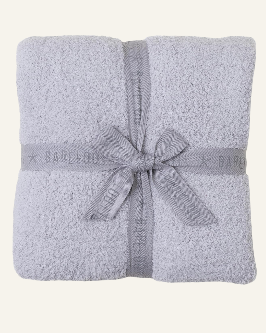 cozy grey blanket with darker grey fabric ribbon with Barefoot Dreams name