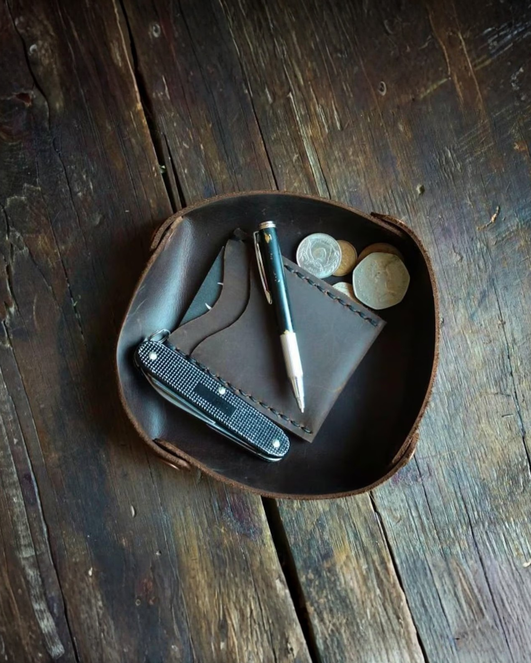handmade, brown leather valet tray, pen, coins, pocket knife