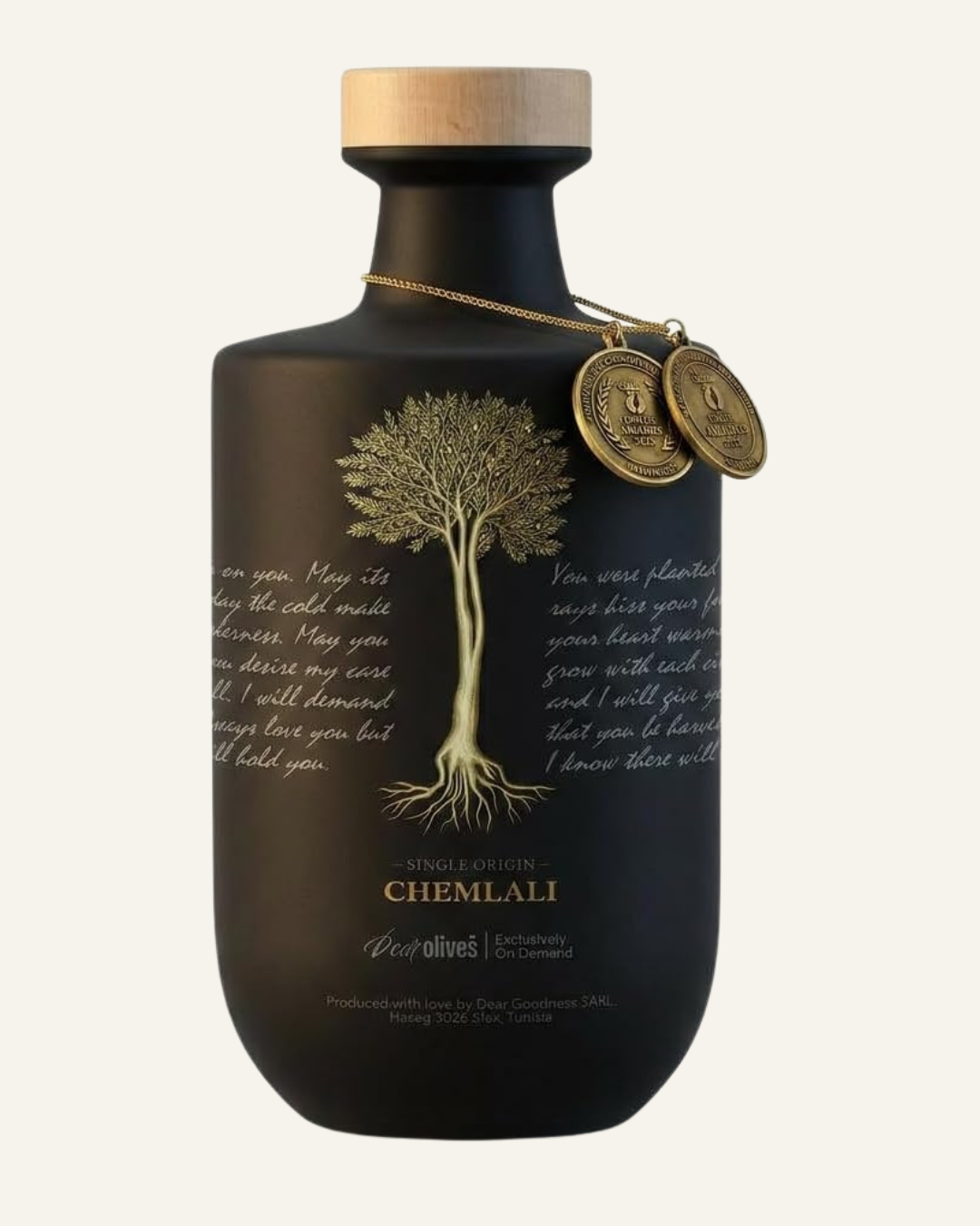 brown glass bottle with wooden lid. Image of an olive tree in gold and text Single Origin Chemali along with some cursive writing around the bottle