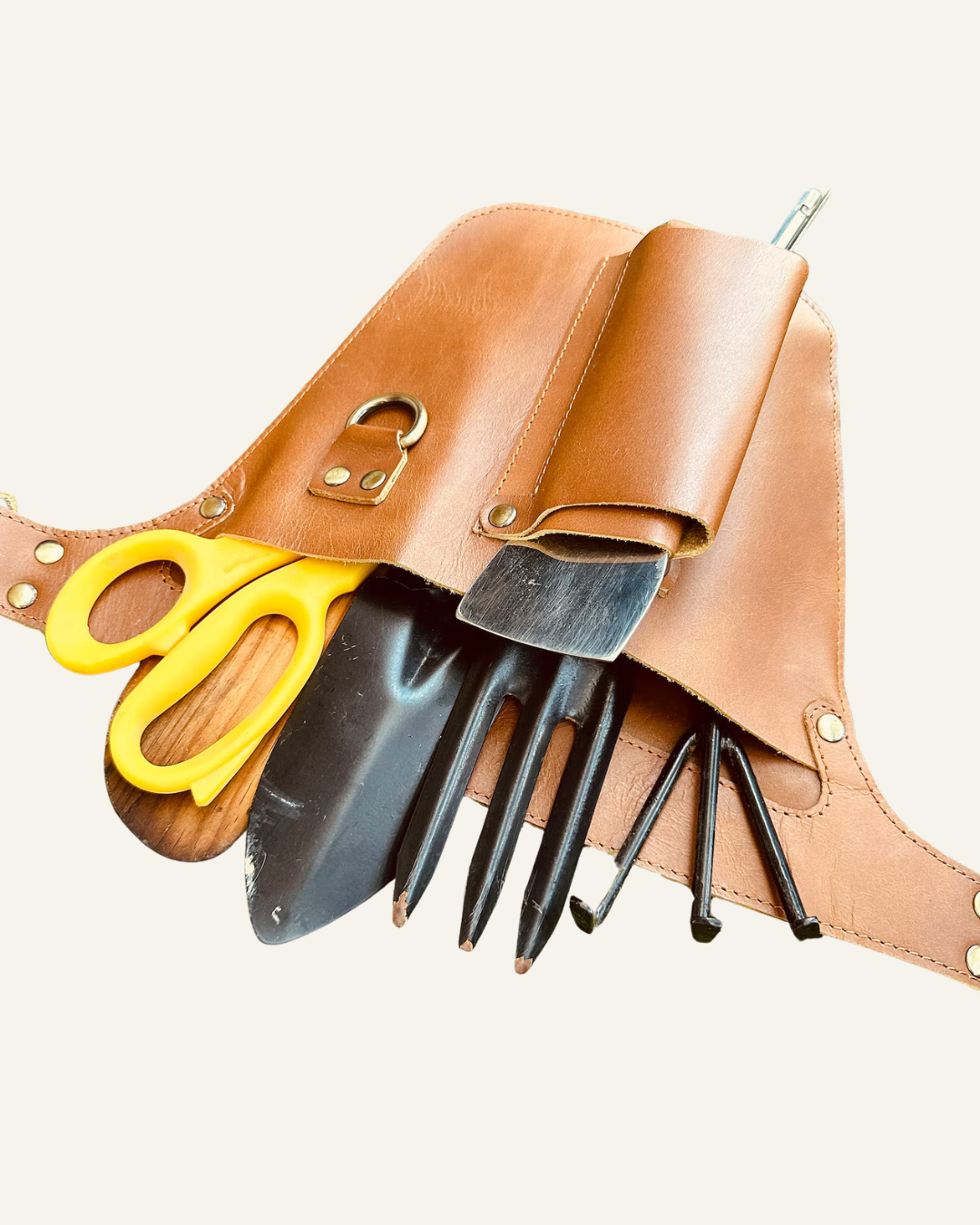 leather gardening tool belt with scissors and tools in it