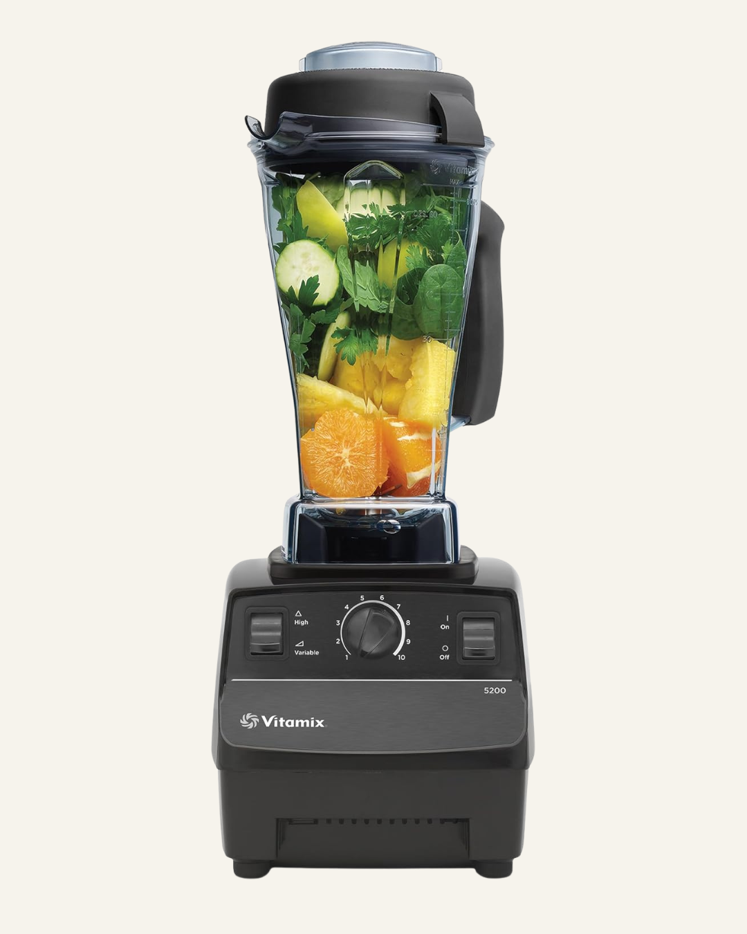 Black blender with jug on top containing oranges, pineapple, cucumber and spinach, with text Vitamix and 5200 on the front