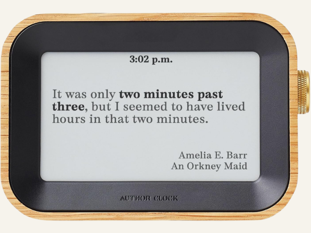 a clock inset in a wooden Frame with text 3:03pm and "It was only two minutes past three, but I seemed to have lived hours in that two minutes." Author clock