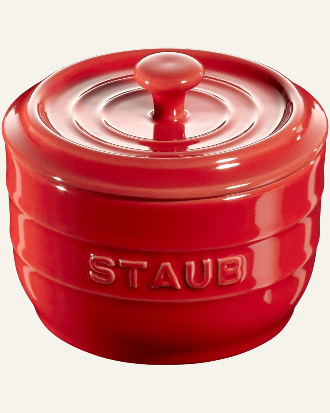 red ceramic salt cellar with text Staub across front and a lid with knob
