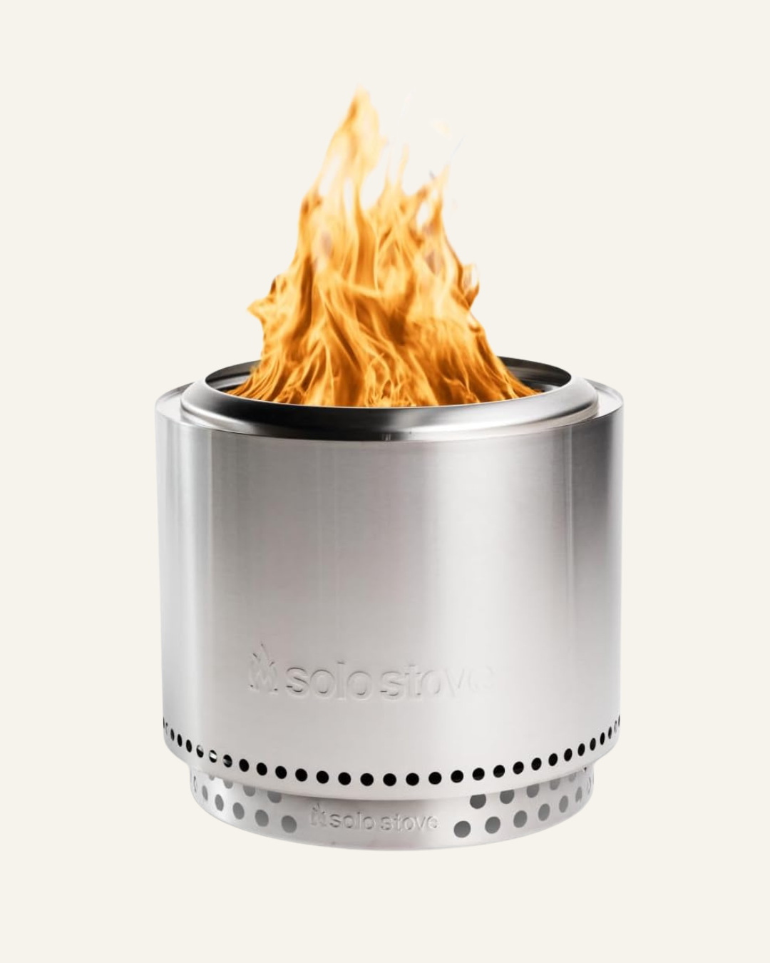 stainless steel bonfire pit with a fire burning inside and text solo stove on the front